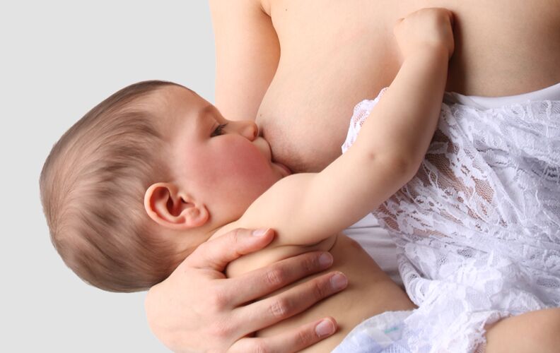 Baby is breastfed by mother